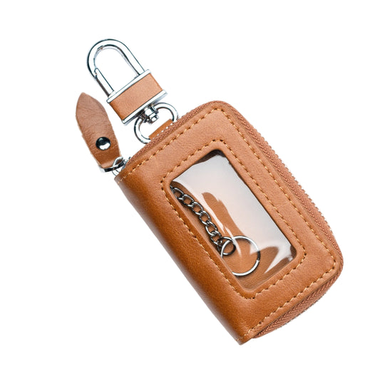 A brown genuine leather car key holder with a keychain attachment and a small chain attached to it.
