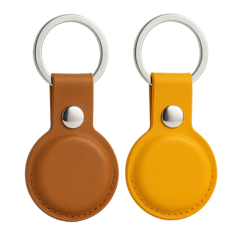 Two leather keychains with metal rings on a white background