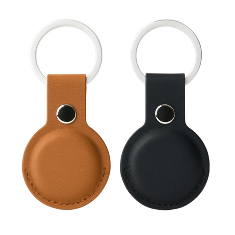 Two round keychains with leather straps, one brown and one black, on a white background.