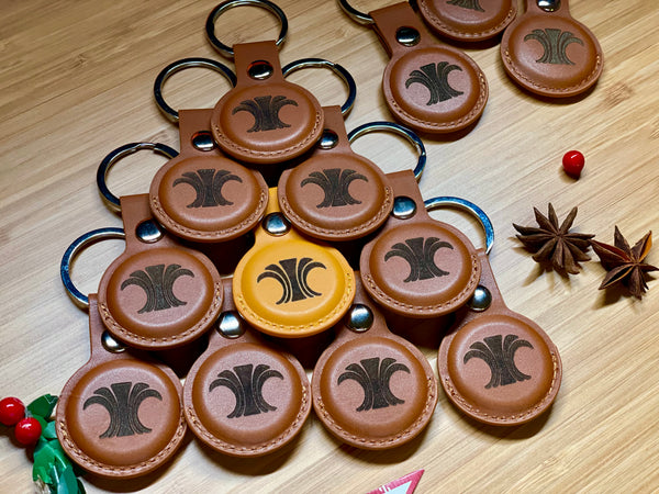 Bulk run of personalized leather AirTag holders ready to ship