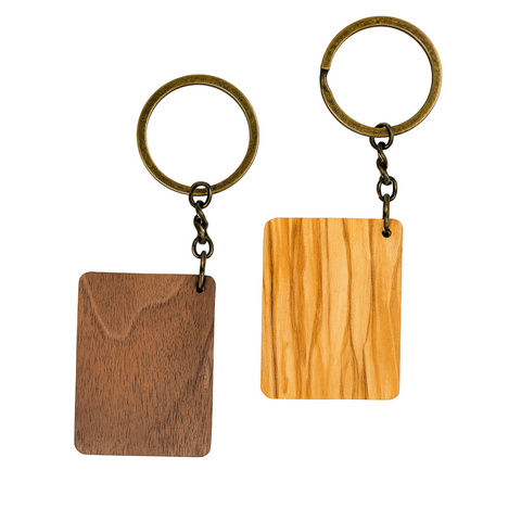 Two wooden keychains with metal loops on a white background